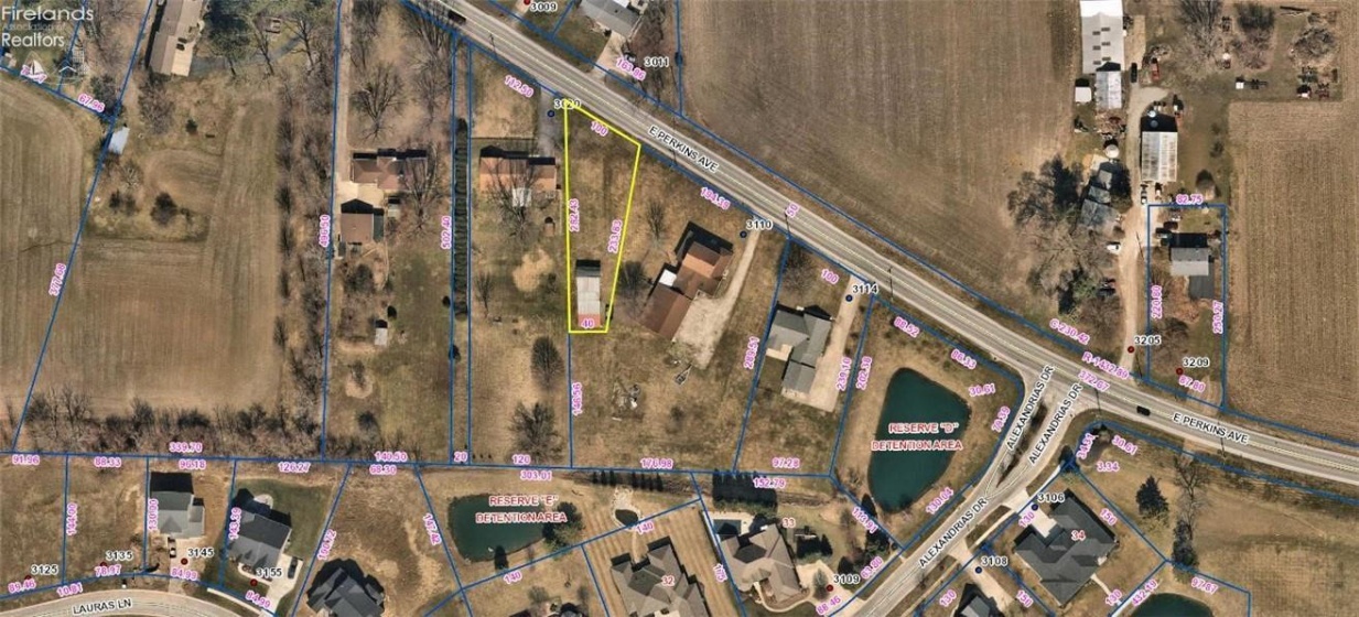 Aerial view the lot outlined in yellow is the property that is for sale.