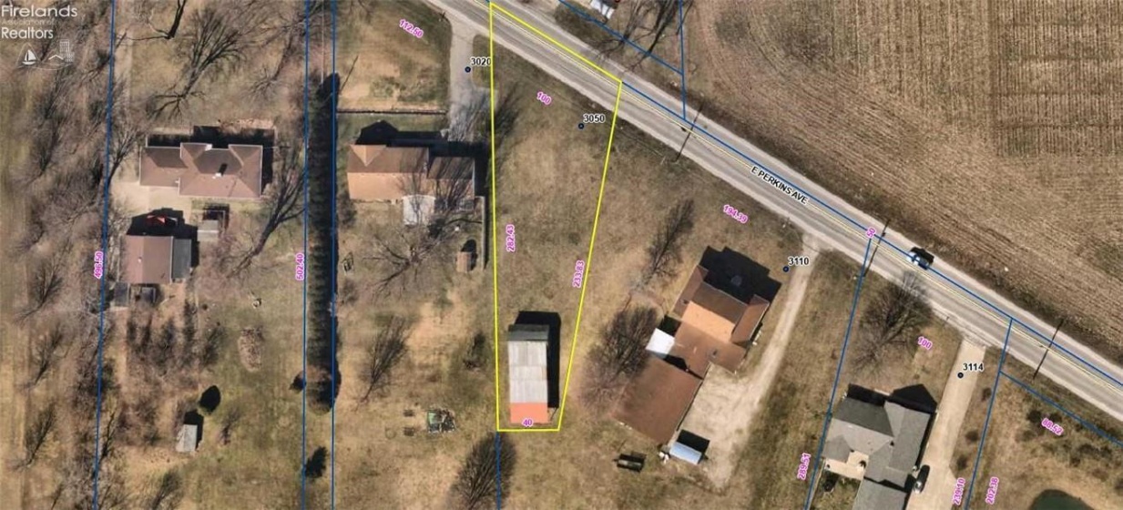 Aerial view the lot outlined in yellow is the property that is for sale.