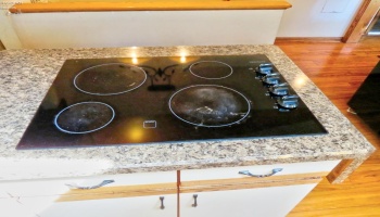 Cooktop stove on kitchen island.