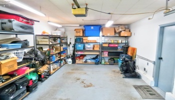Interior of attached garage with direct access to bonus room and workshop/storage room.