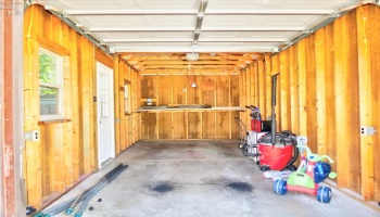 Interior of detached one car garage with direct access to back yard.