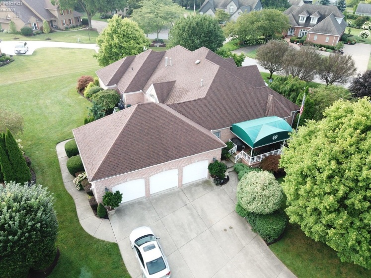 Oversized 3 car garage w/ additional kitchen and view of side covered patio