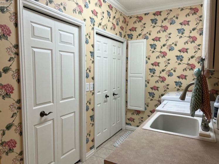 Tons of closets/storage in laundry room with built in pull down ironing board