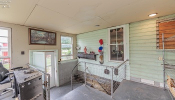 Enclosed porch with access to basement and side flower garden