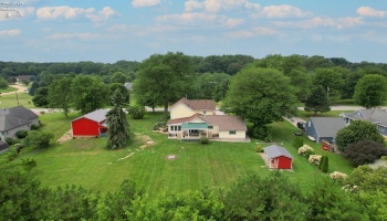 Drone view of back of home and outbuilding