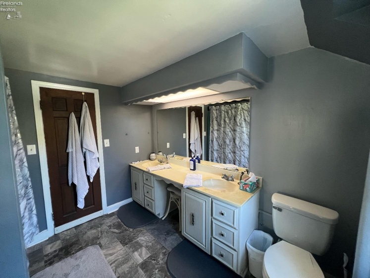 Full bathroom upstairs with adjoining bedroom access.