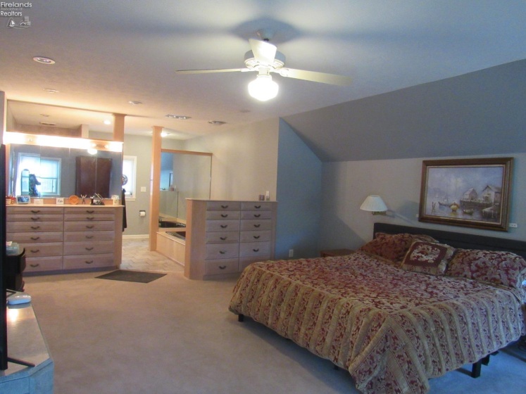 20'x24' Main bedroom suite with built in dressers, jet tub, walk in tile shower