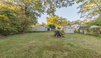 Backyard with fencing on three sides, would only need to add fencing on each side of house to be completely fenced in.