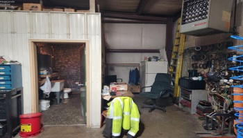 Inside the newer metal building, bathroom, lunch room on the right and back-up gas heater. Inside the newer metal building, bathroom, lunch room on the right and back-up gas heater.