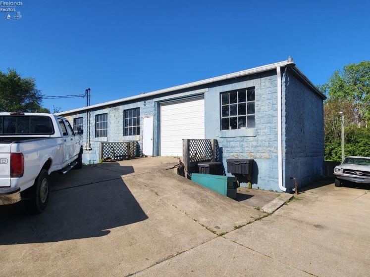 Back view of the block building, newer gutters and downspouts.