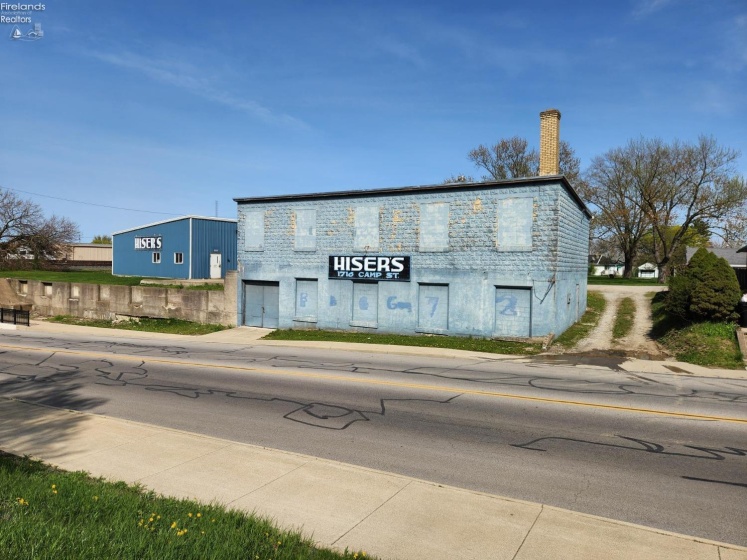 2 Buildings, one is block and the other is metal, the stone driveway to the right belongs with this property