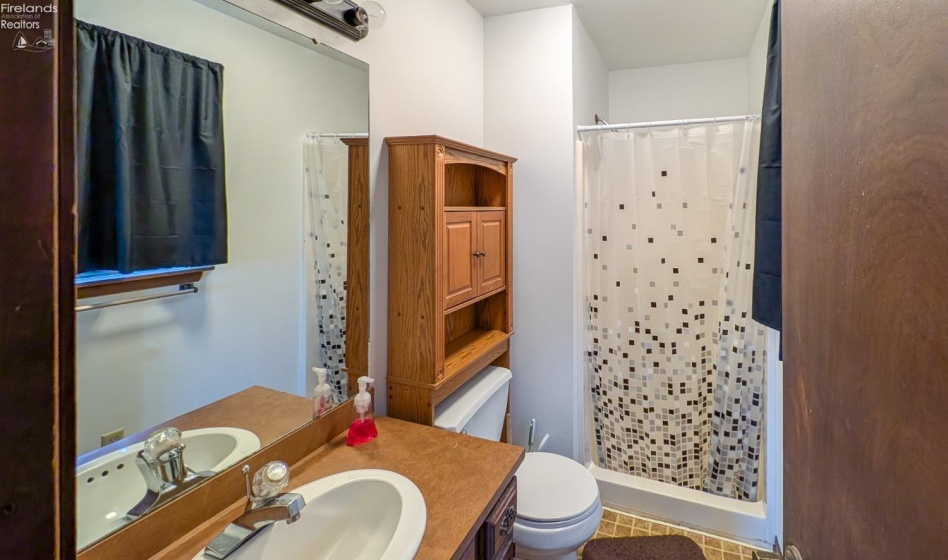 Full bath with walk-in shower in primary bedroom