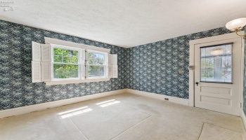 Primary bedroom with en-suite sleeping/sitting porch with western sunset views and overlooking the rear garden