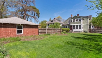 Garden with full privacy fence with daffodils and other perennials
