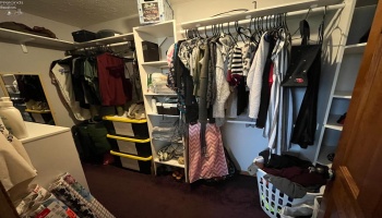 Primary bedroom walk-in closet