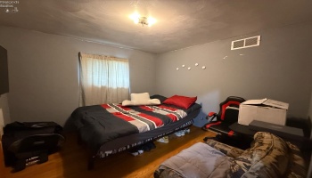 Bedroom with natural hardwood floors