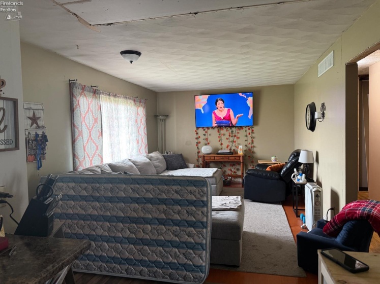 Living room area is now open to the kitchen- ceilings will need to be refinished
