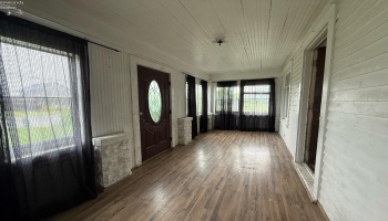 Enclosed porch at front entry