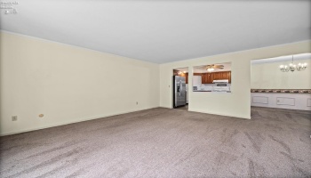 Living room looking into kitchen and dining room