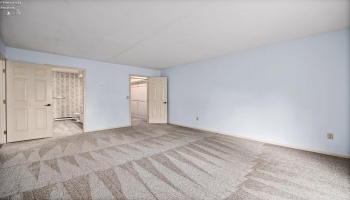Owner bedroom with entry to owner bathroom and walk in closet