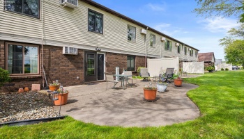 Back elevation and backyard patio with entry to community room