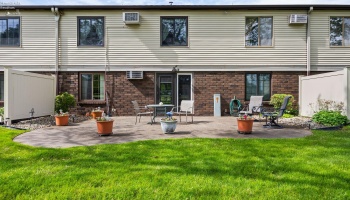 Back elevation / community patio with entry to community room