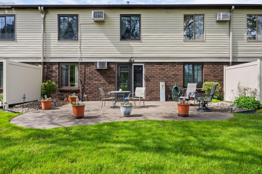 Back elevation / community patio with entry to community room