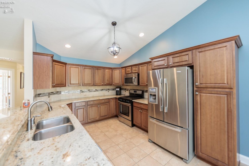 Kitchen with granite counters, stainless appliances and plenty of cupboard storage.