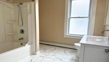 Renovated full bath with laundry hookup