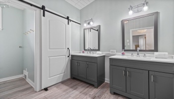 Full bath with two sinks and separate toilet closet and shower