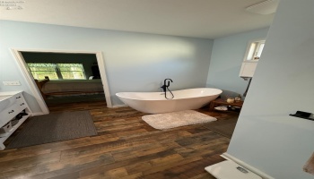 The Owner\'s Bath has a soaking tub plus a large fiberglass shower with a rain head.