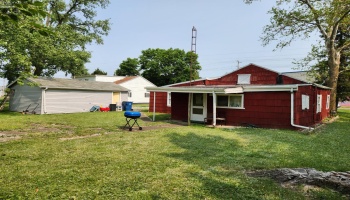 Back of the home and back of the detached garage.