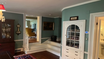 Built-in china cabinent with steps up leading to Family room and office to the right.