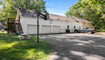 First 3-car garage on the left or East end with lots of parking, the 900 square feet of heated work area on ground level and a 1,600 square foot Apartment above