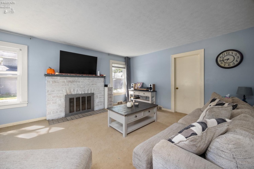 Living room with wood burning fireplace