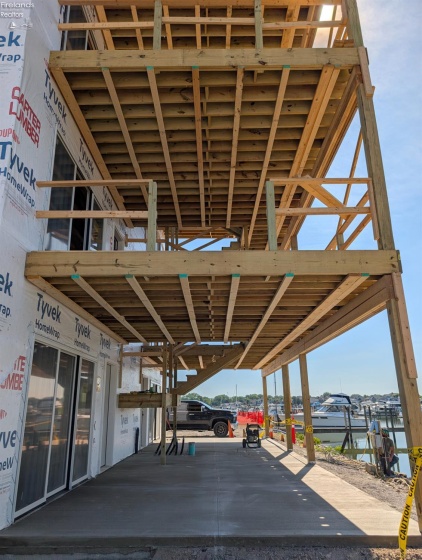 First floor covered concrete patio, second and third floor balconies